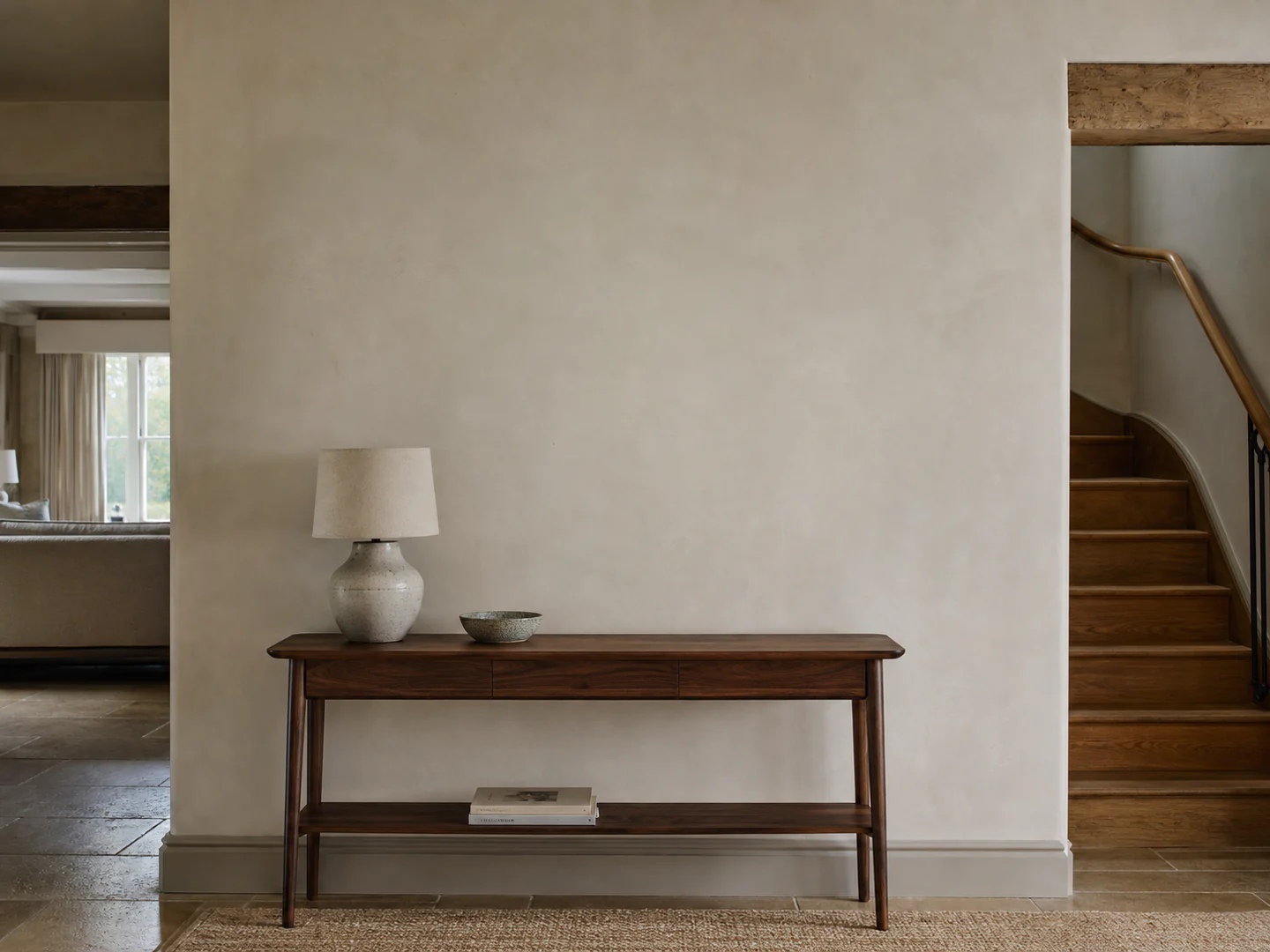A warm British entrance hall with a portrait above a console table
